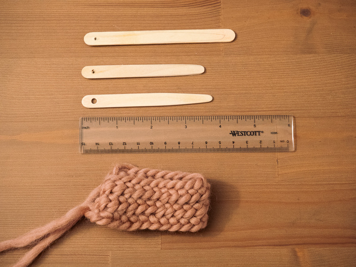 Popsicle sticks being turned into nalbinding needles